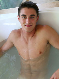 Muscled stud relaxing in the bath and stroking his tool