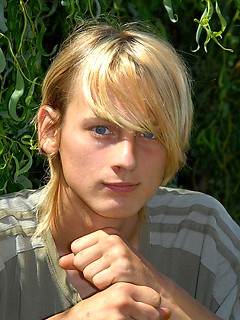 Naked blonde teen boy posing in the garden