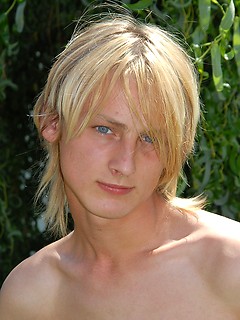 Naked blonde teen boy posing in the garden