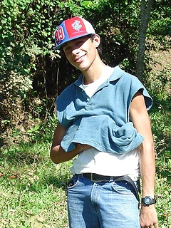 Handsome latin twink strips and poses outdoors