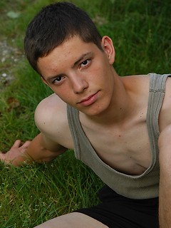 Small twink guy posing naked outdoors