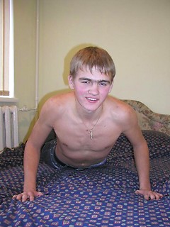 Cute twink is posing off his body for the camera