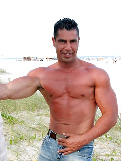 Beefy latino dad Leo Rojas posing on the beach