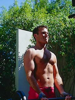 Toned hunk working out outdoors