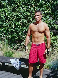 Toned hunk working out outdoors