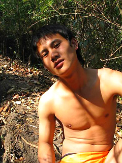 Handsome Thai guy gets naked in the wild