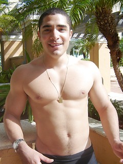 Strong latin guy posing under hot sun