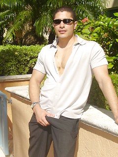 Strong latin guy posing under hot sun