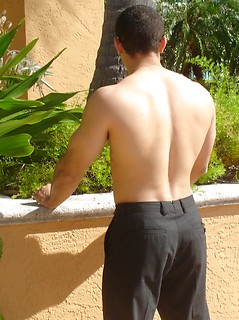 Strong latin guy posing under hot sun