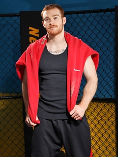 Sporty redhead dude workout in the gym