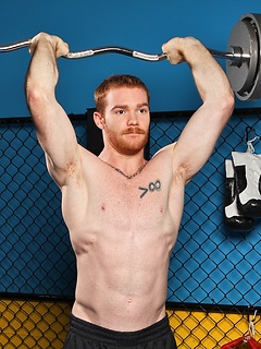 Sporty redhead dude workout in the gym