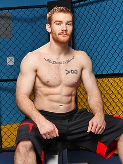 Sporty redhead dude workout in the gym