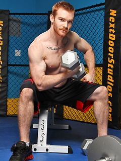 Sporty redhead dude workout in the gym