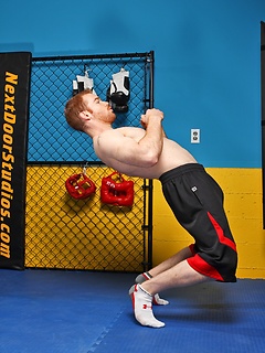 Sporty redhead dude workout in the gym