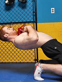 Sporty redhead dude workout in the gym