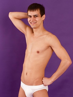 Pretty sporty straight guy is posing in white briefs and socks