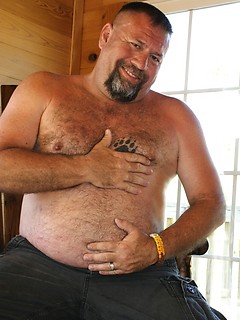 Grizzly Daddy Jake Davidson strips off his T-Shirt and shows off his hairy belly and hard cock
